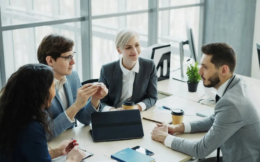 Business professionals reviewing analytics reports and performance data during a strategic meeting, demonstrating data-driven decision making in a modern organization.