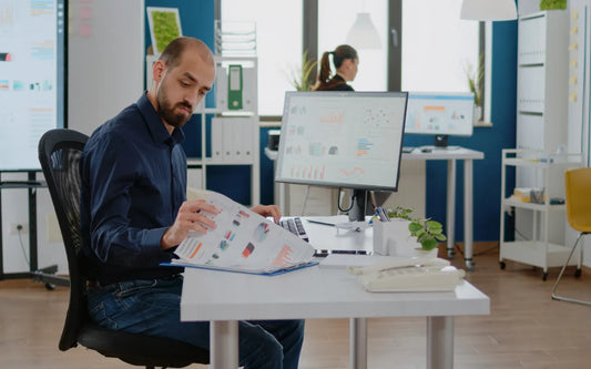 Corporate Data Protection Officer (DPO) evaluating GDPR compliance documents and data charts for a business in Spain.