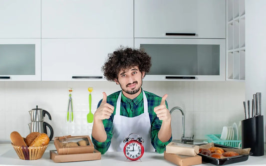 Course banner for "Fitness to Work: When Food Handlers Must Stay Off (48-Hour Rule)," featuring a male food handler in a white apron giving two thumbs up behind a kitchen counter with a red alarm clock, fresh bread, and packaged pastries.