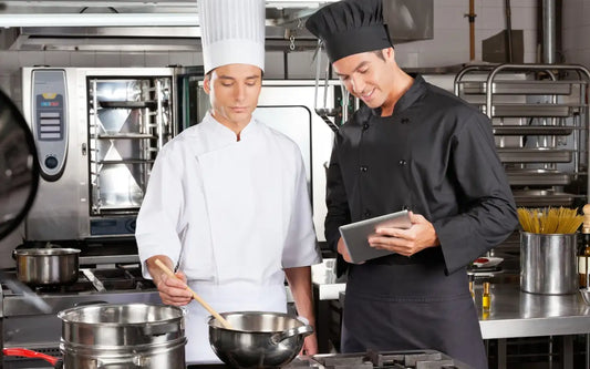 Food Handler Certificate in Spanish 2026 guide banner showing two chefs in a restaurant kitchen using a tablet