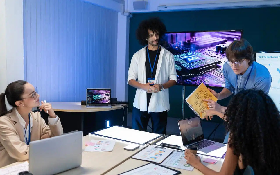 A group of professionals collaborating in an office during a strategy meeting on generative AI, with a man holding up a business plan document and presenting to colleagues seated at desks with laptops and charts