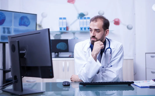 Healthcare provider reviewing cybersecurity systems and digital health records to ensure NIS2 compliance, cyber resilience, and patient data protection in Spain.