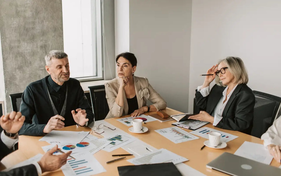NIS2 Compliance for SMEs in Spain 2026 guide banner showing executives discussing cybersecurity strategy around a conference table
