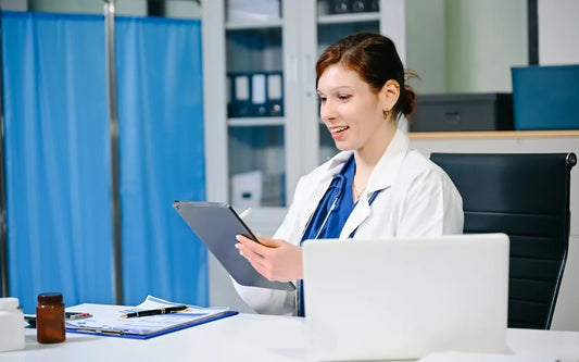 Patient Data Protection in Spain guide banner showing a female doctor reviewing digital records on a tablet in an office