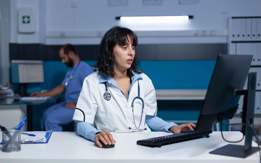 Healthcare provider reviewing cybersecurity systems and digital health records to ensure NIS2 compliance, cyber resilience, and patient data protection in Spain.